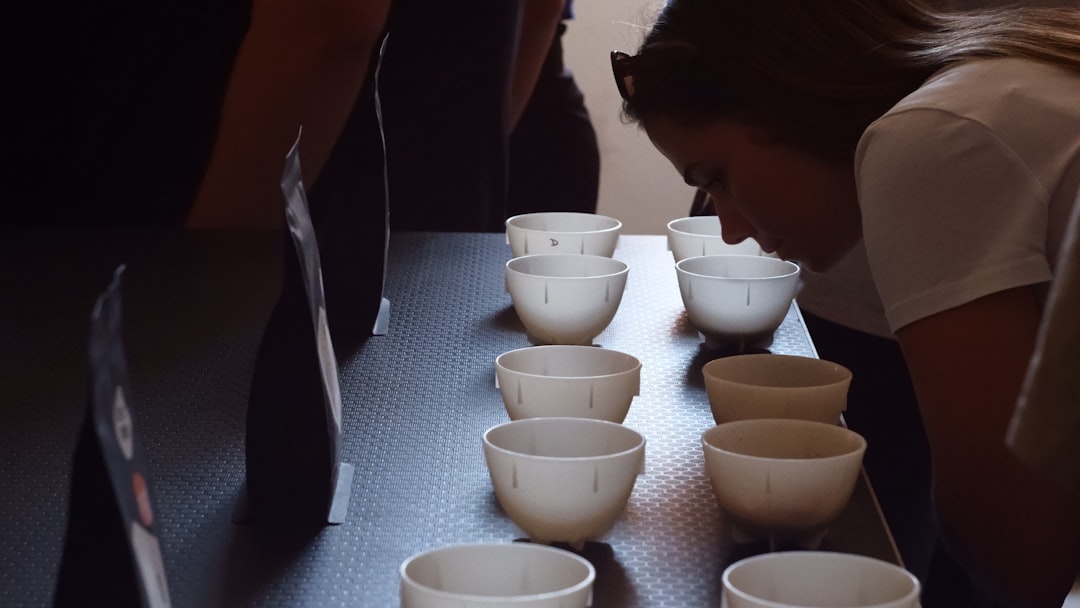 People smelling samples in small white cups