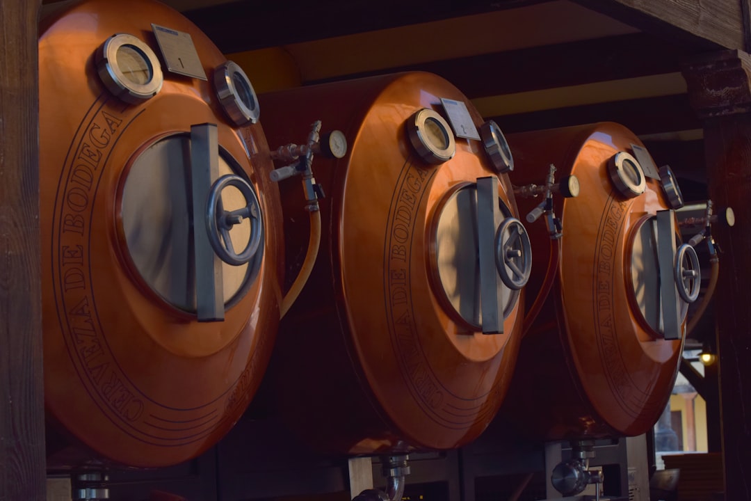 Copper tanks with gauges and valves are aligned.