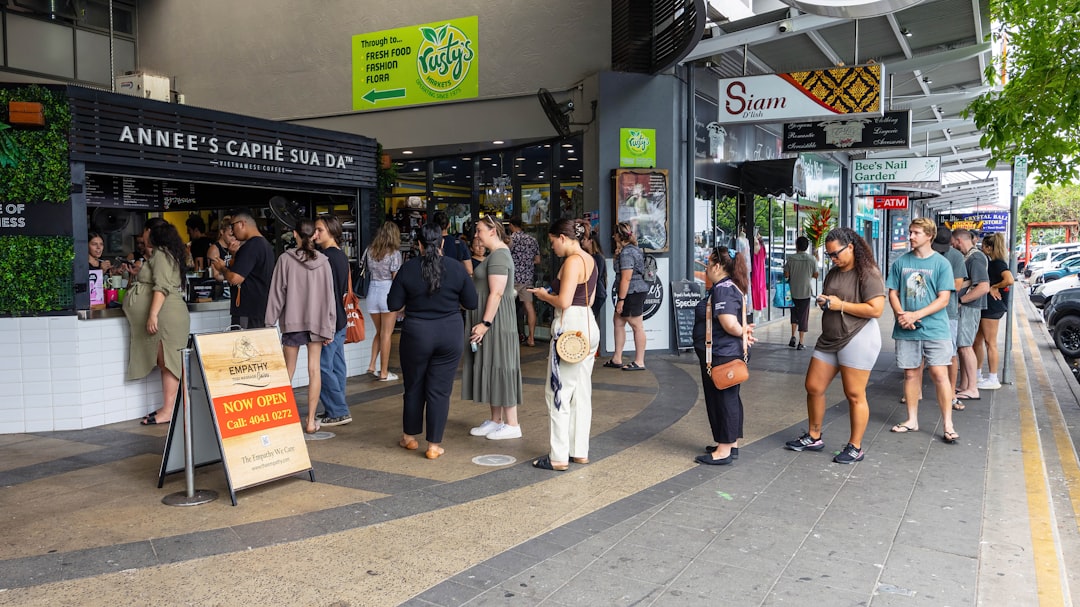 A group of people standing outside of a store