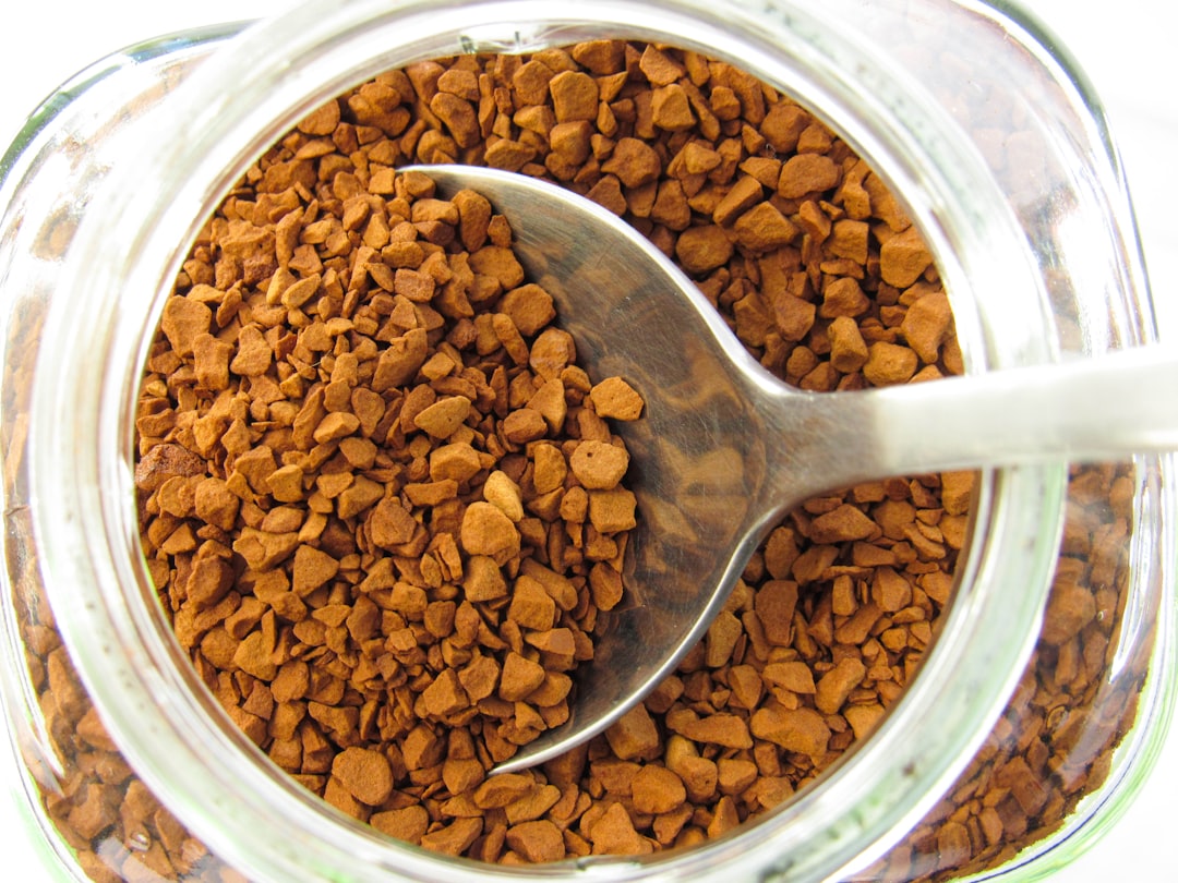 A spoon in a jar filled with dog food