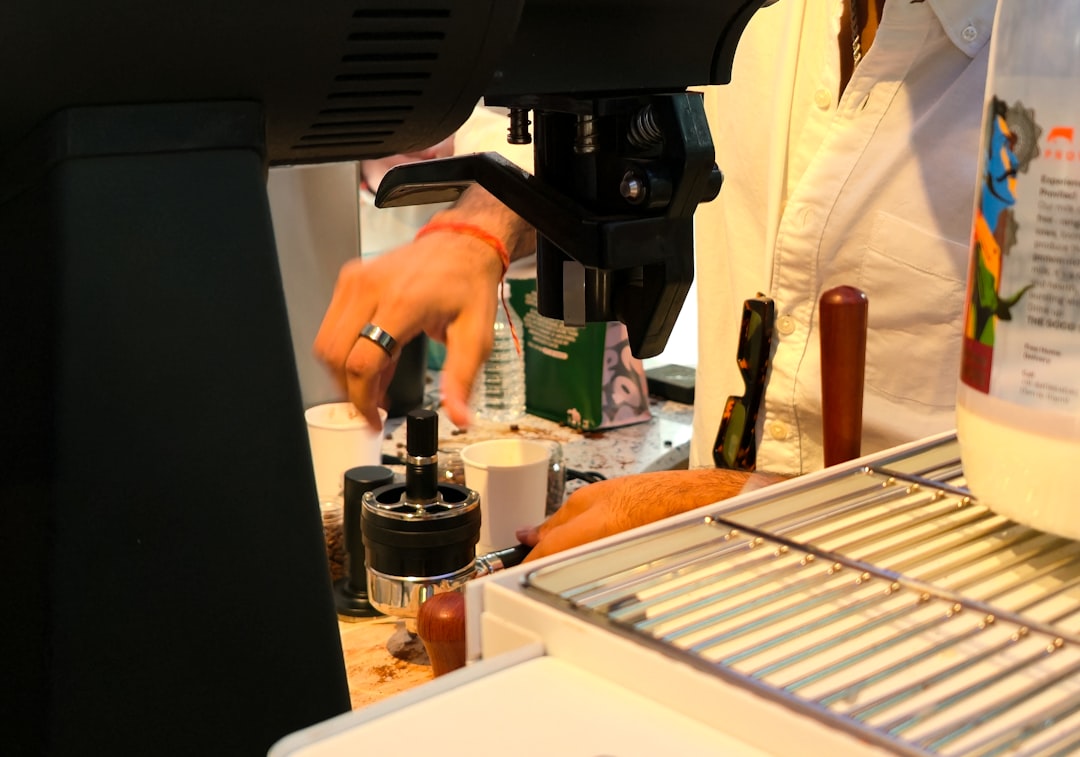 Barista preparing a drink at a coffee machine.